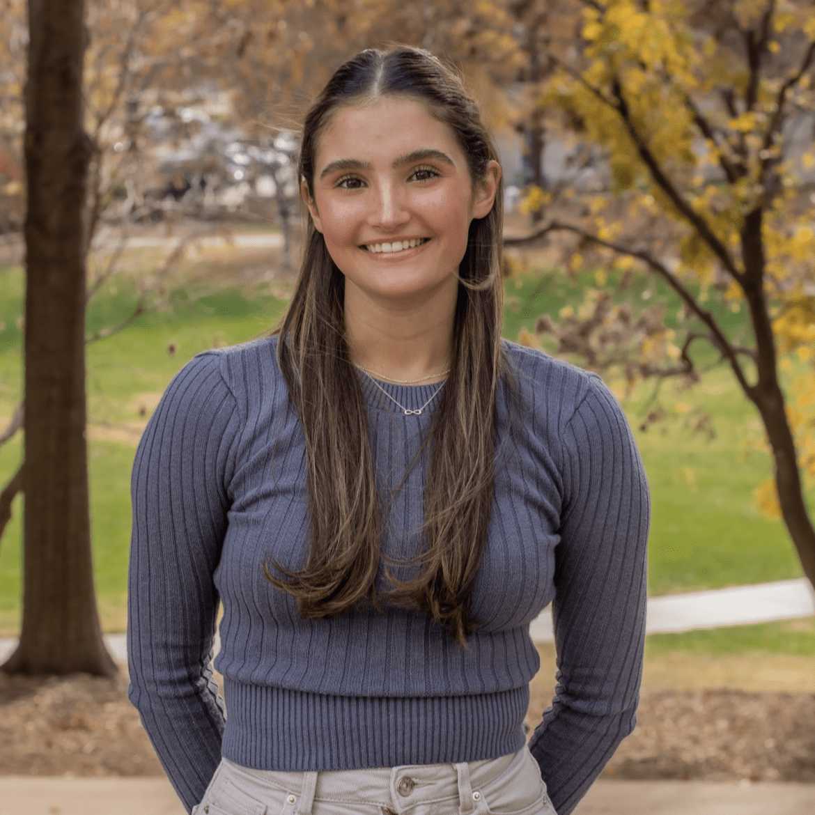 Katie is standing in front of McKeldin Mall and smiling at the camera