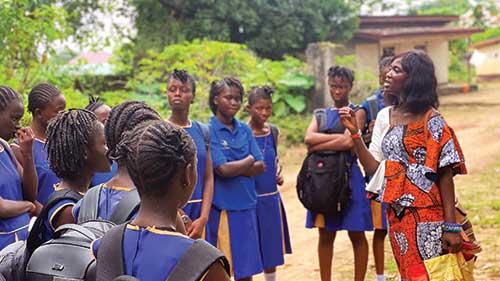 Binta Jalloh works with a group of female students in Sierra Leone