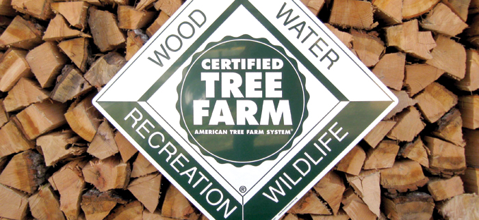 American Tree Farm logo against a stack of cut firewood logs