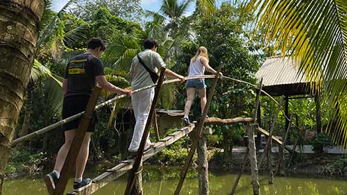 Students walking over a bridge Vietnam