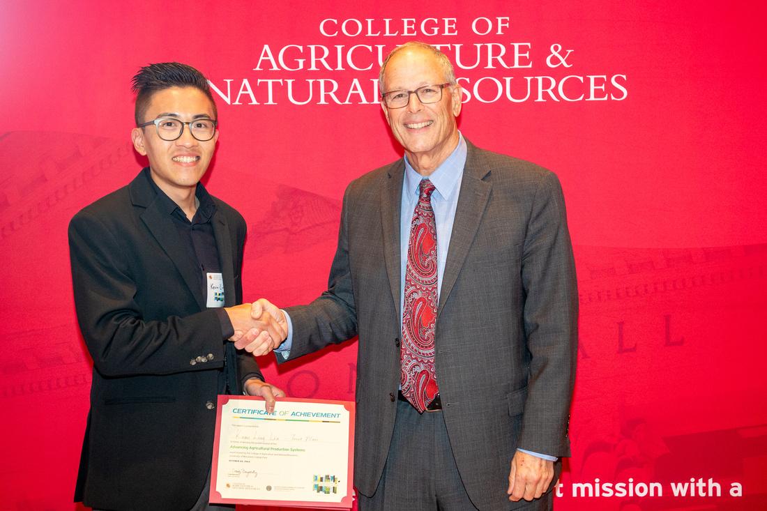 Student poster award winner with Dean Beyrouty